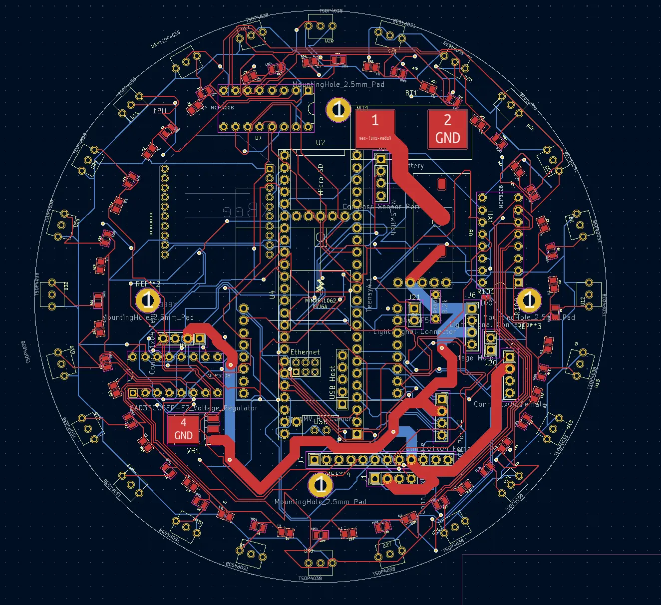 KiCad layout of the finalized round main board: red top and blue bottom traces, the Teensy footprint in the middle and a ring of sensor pads near the edge.