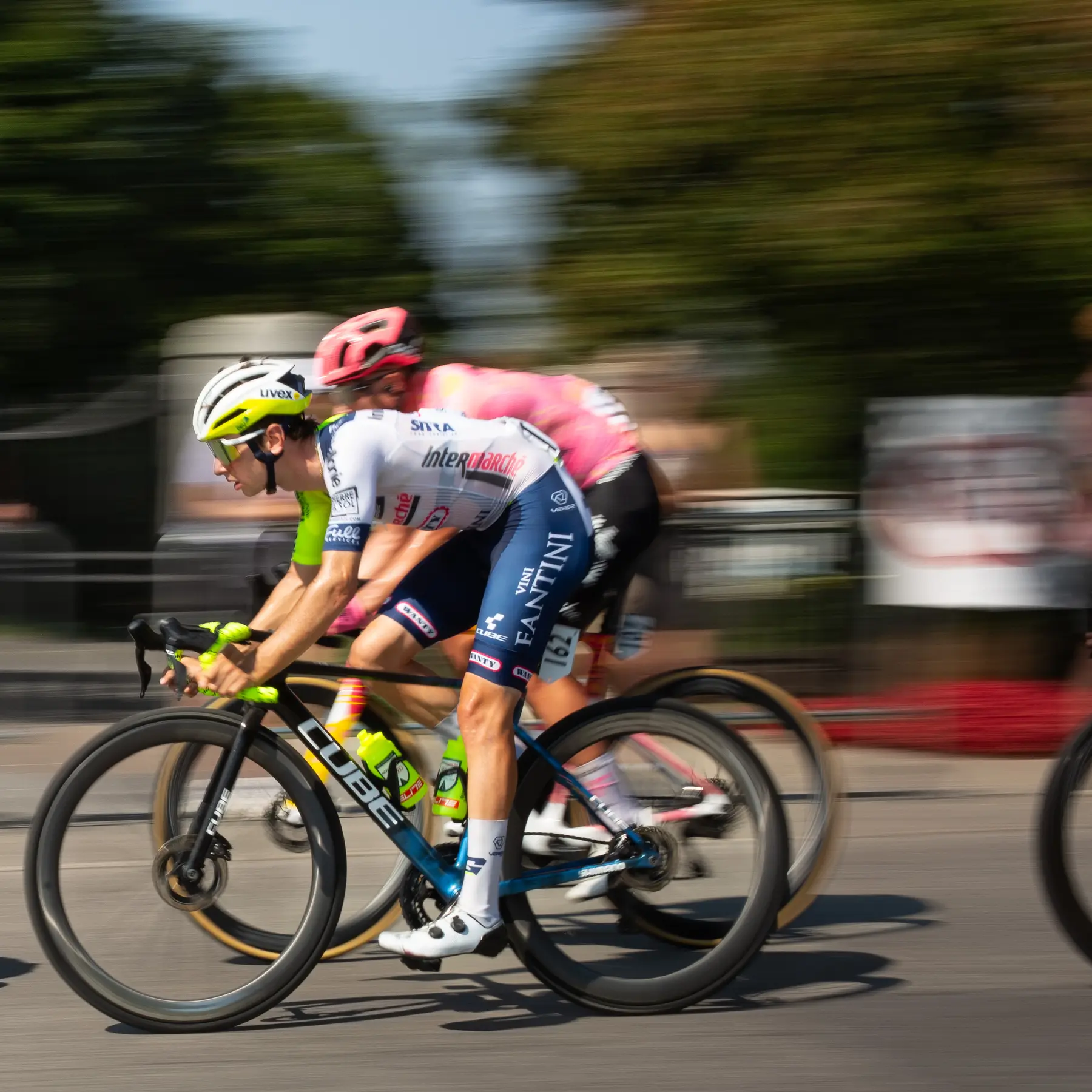 The same rider a moment later, wheels sharp against a blurred crowd.